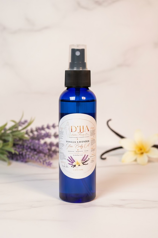 Blue bottle with black spray nozzle labeled 'D'Jia Vanilla Lavender' on a white surface with greenery in the background.